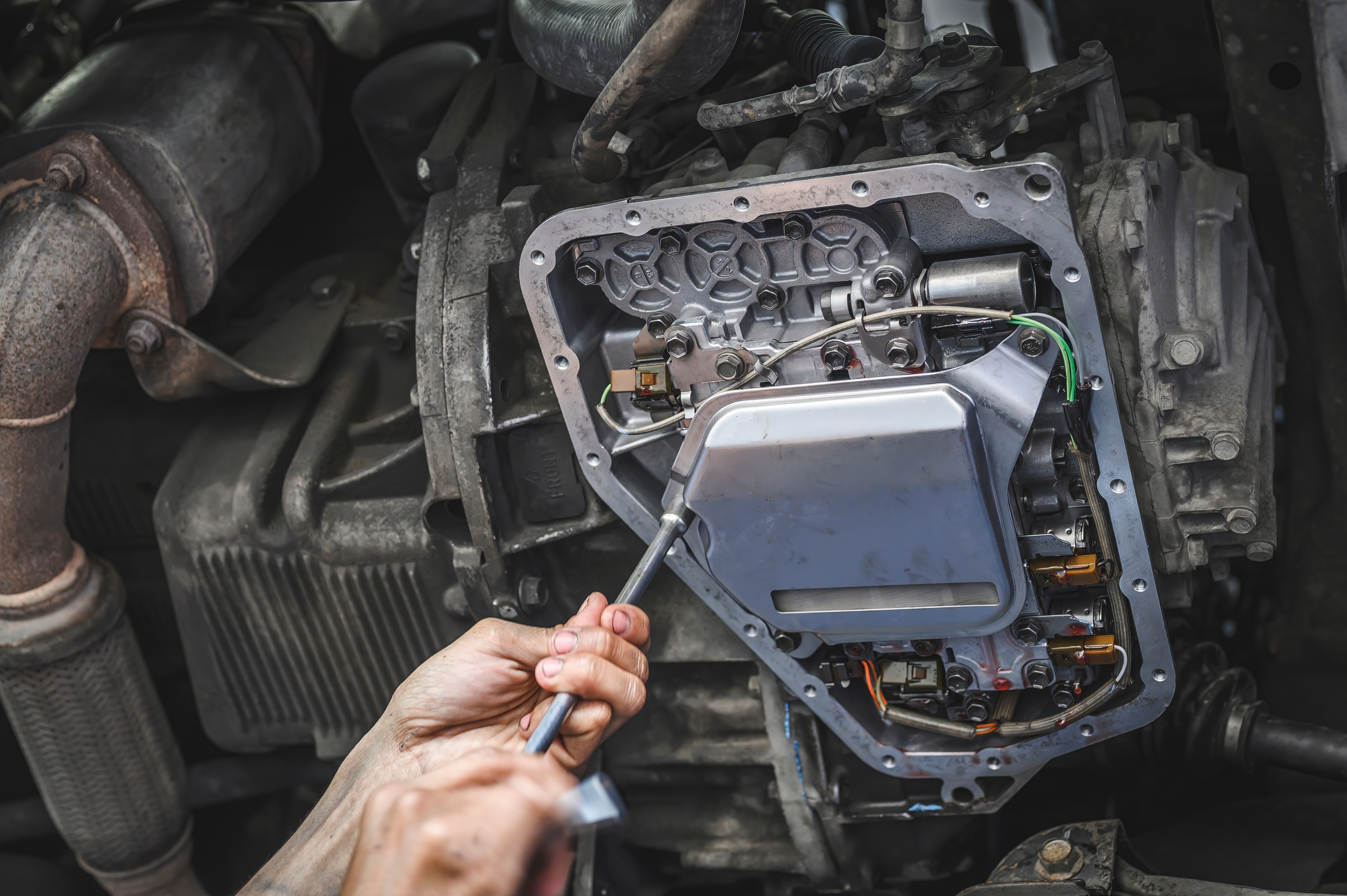 Technician working on a transmission valve body